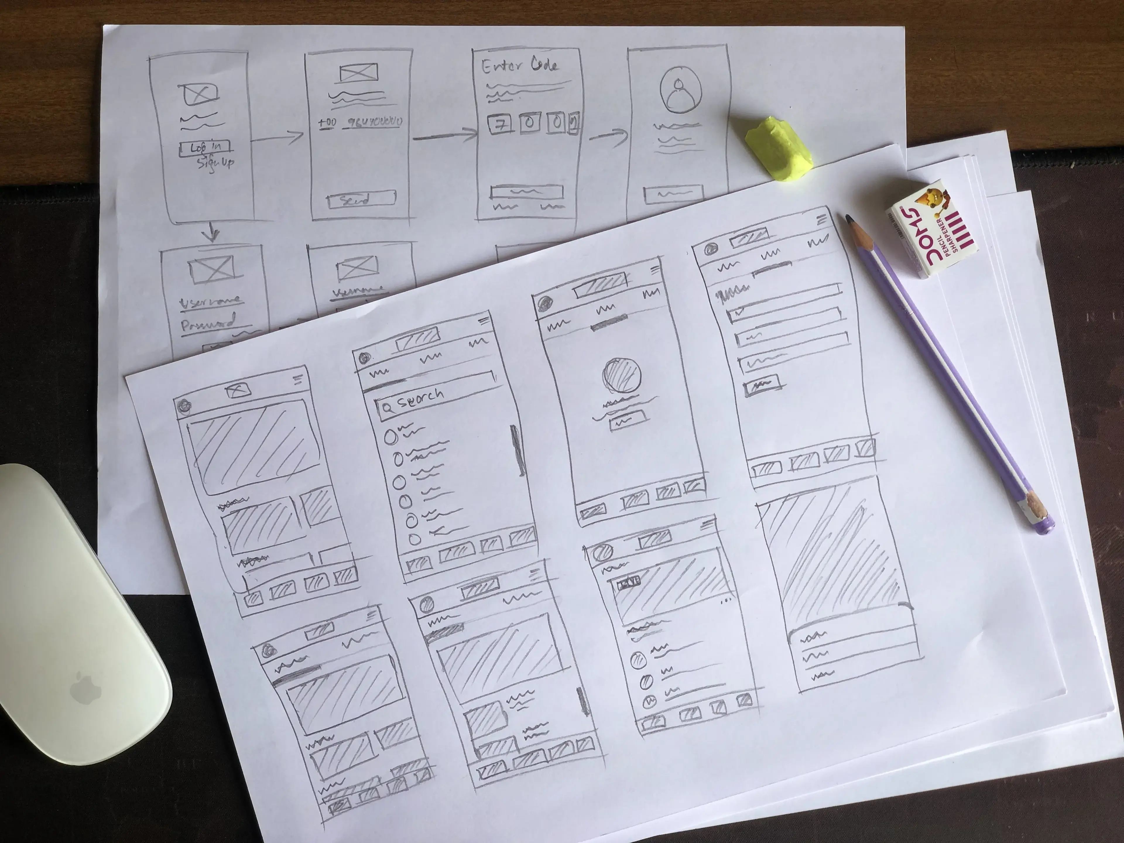 Hand-drawn paper wireframes sketching the sign-up, phone verification, and core app screens